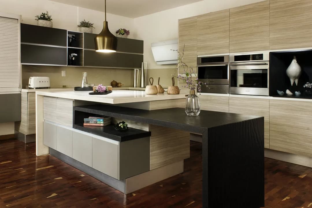 Modern kitchen design featuring a sleek island, stainless steel appliances, and natural wood accents.