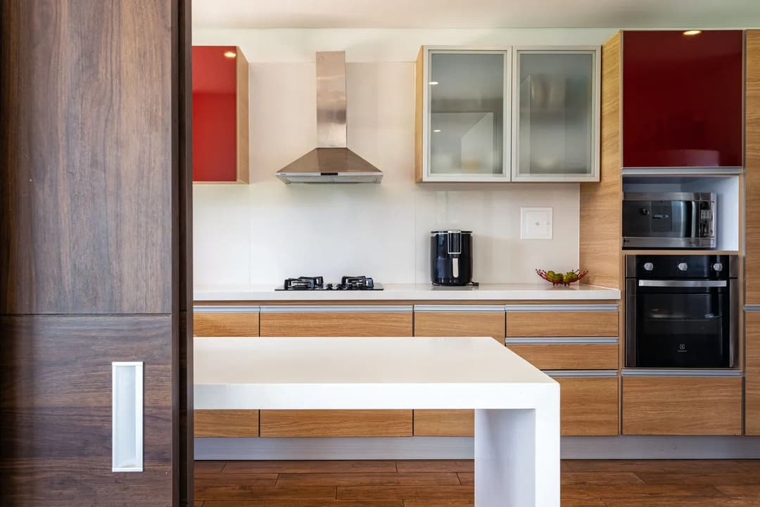 Modern kitchen design featuring wooden cabinetry, sleek appliances, and a minimalist layout.