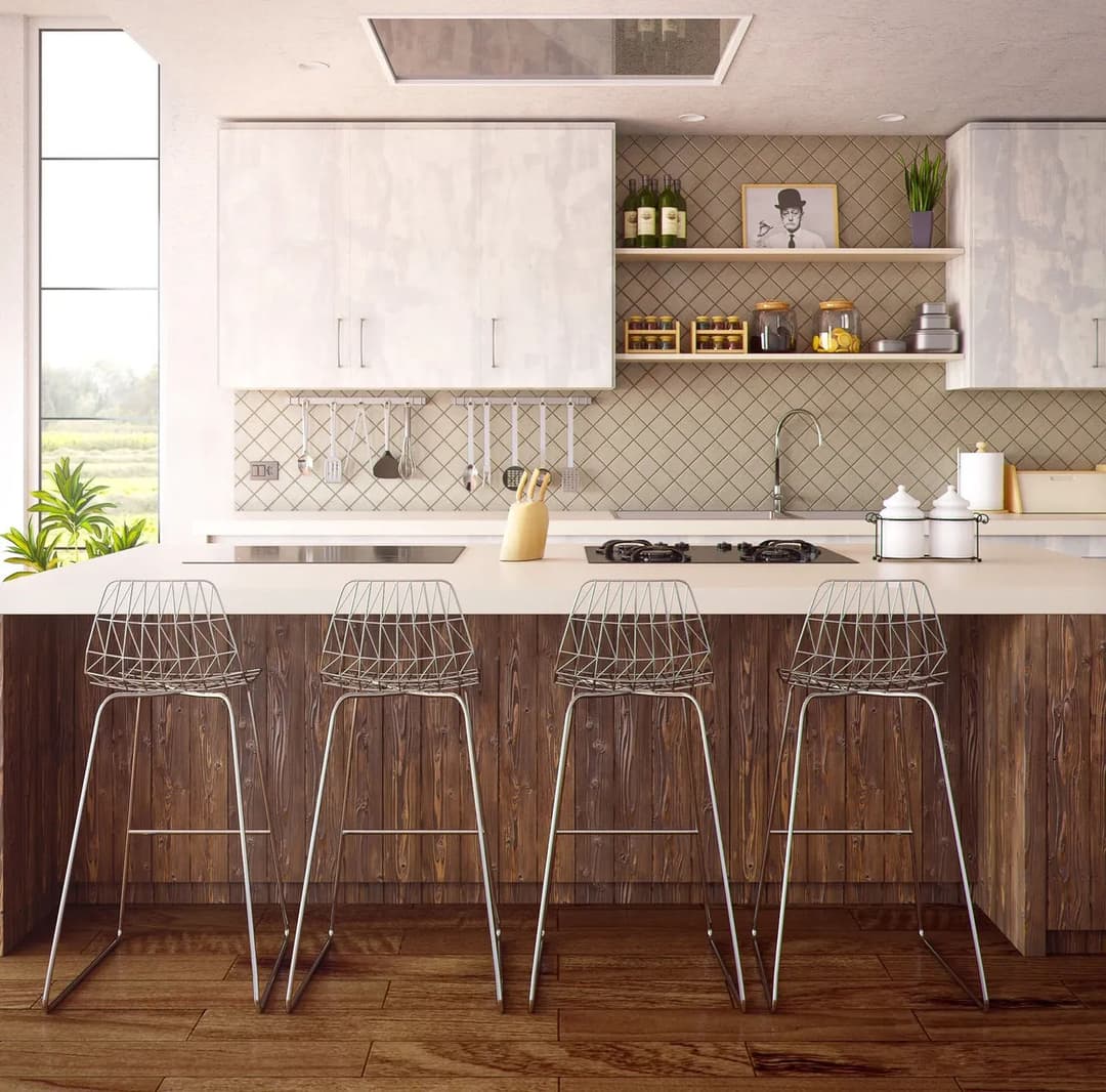 Modern kitchen with white cabinets, wood accents, and stylish wire bar stools.