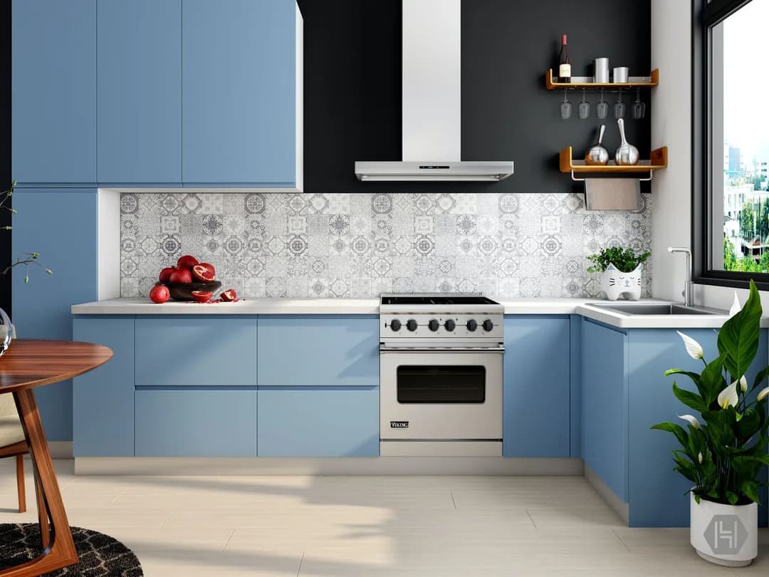 Modern blue kitchen with decorative backsplash, stainless steel stove, and natural lighting.