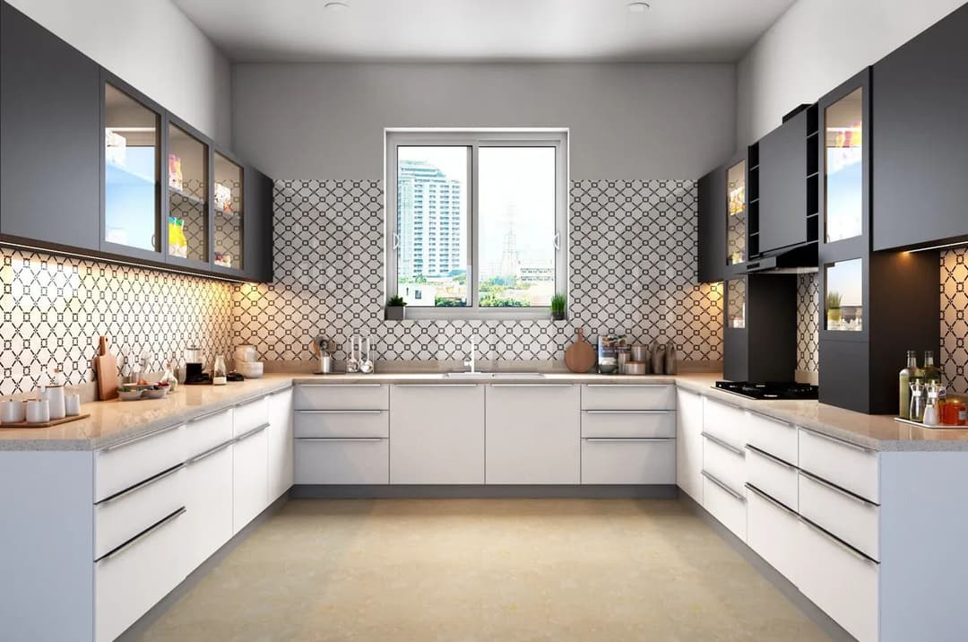 Modern kitchen with gray and white cabinetry, geometric backsplash, and a city view.