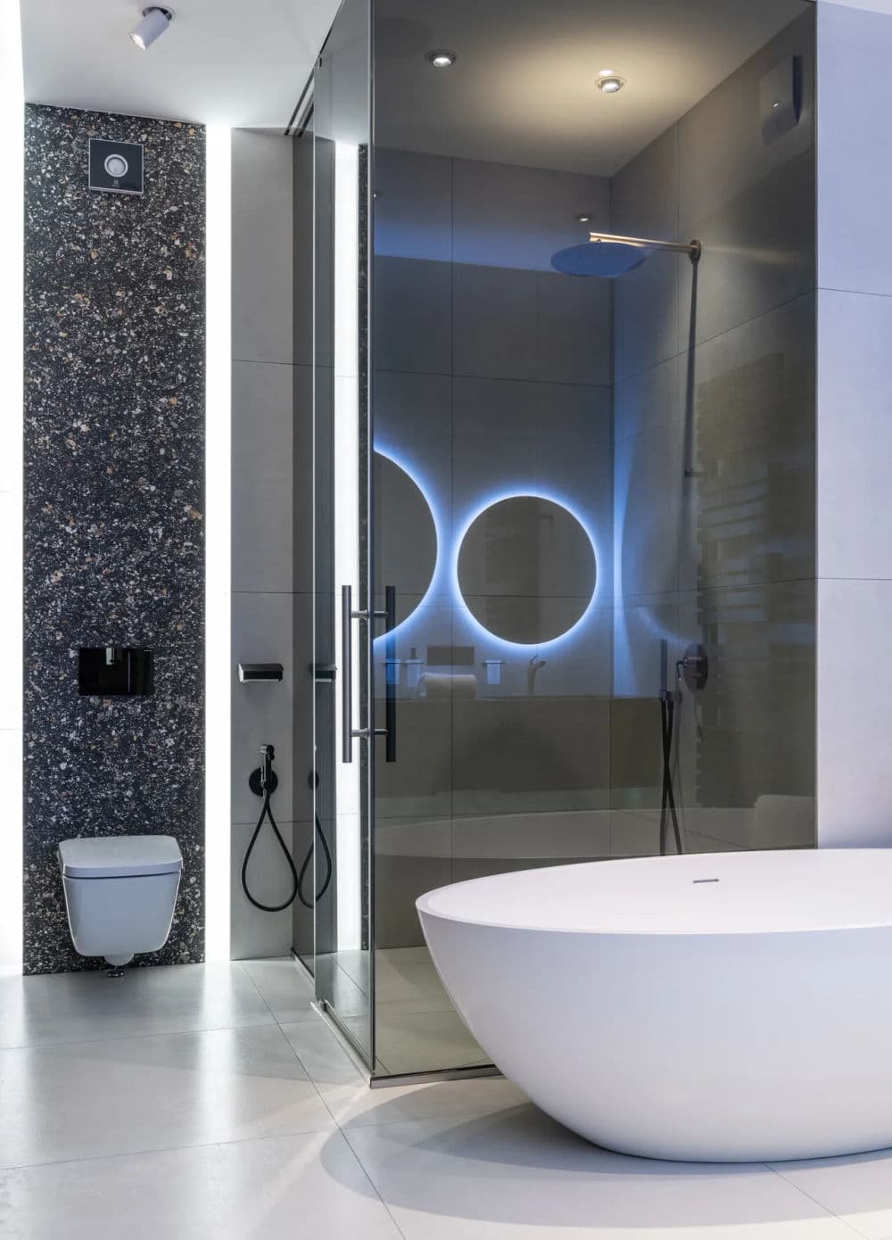 Modern bathroom design featuring a sleek glass shower, freestanding tub, and stylish lighting.